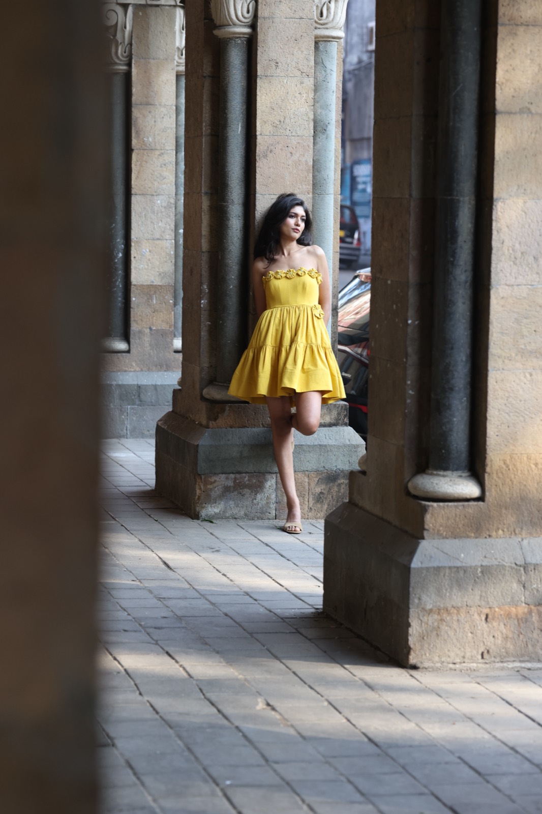 A vibrant mustard-yellow mini crafted in fluid silk crepe, featuring delicate floral appliqué detailing and a playful tiered silhouette. Effortlessly feminine with a sunny, statement-making charm. ✨
