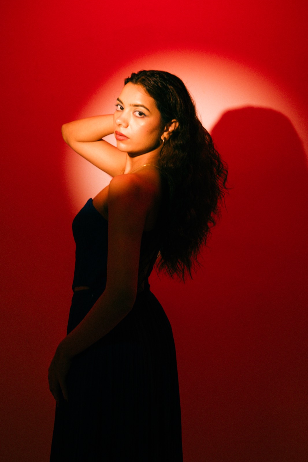 Cobalt Pleated Set — the same gown under a red studio light, which deepens the cobalt to near-black