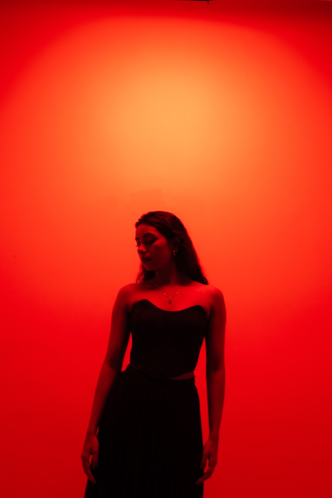 Cobalt Pleated Set — full length against the red light, the pleats falling to the floor