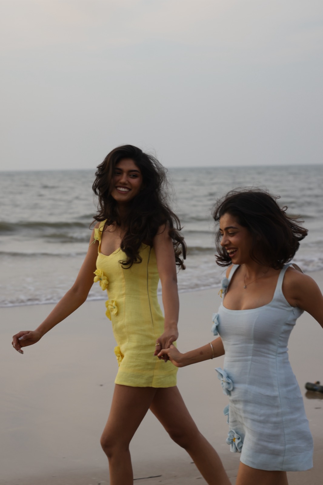 Hibi Yellow and Hibi Blue — both colourways worn side by side on the beach