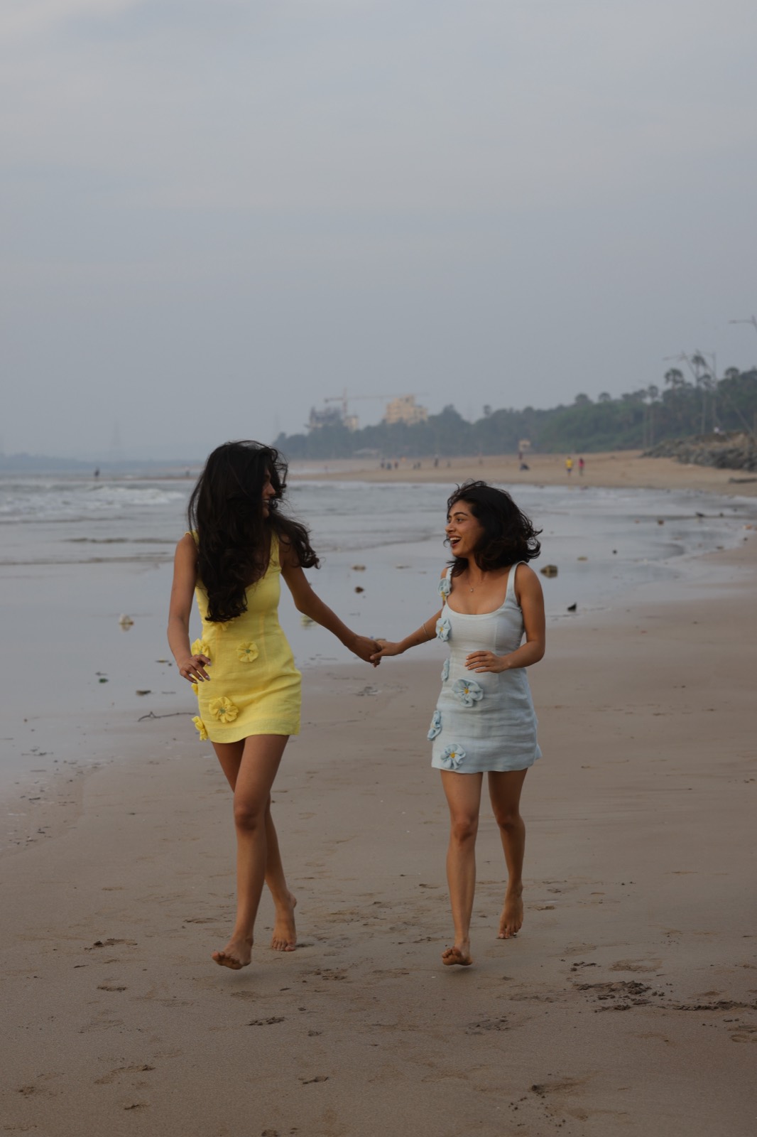 Hibi Yellow and Hibi Blue — both colourways walking the shoreline