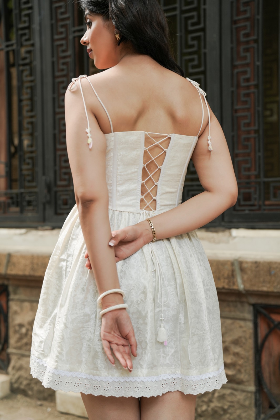 Sunset Brocade — seen from behind, the lattice lacing running down the centre back