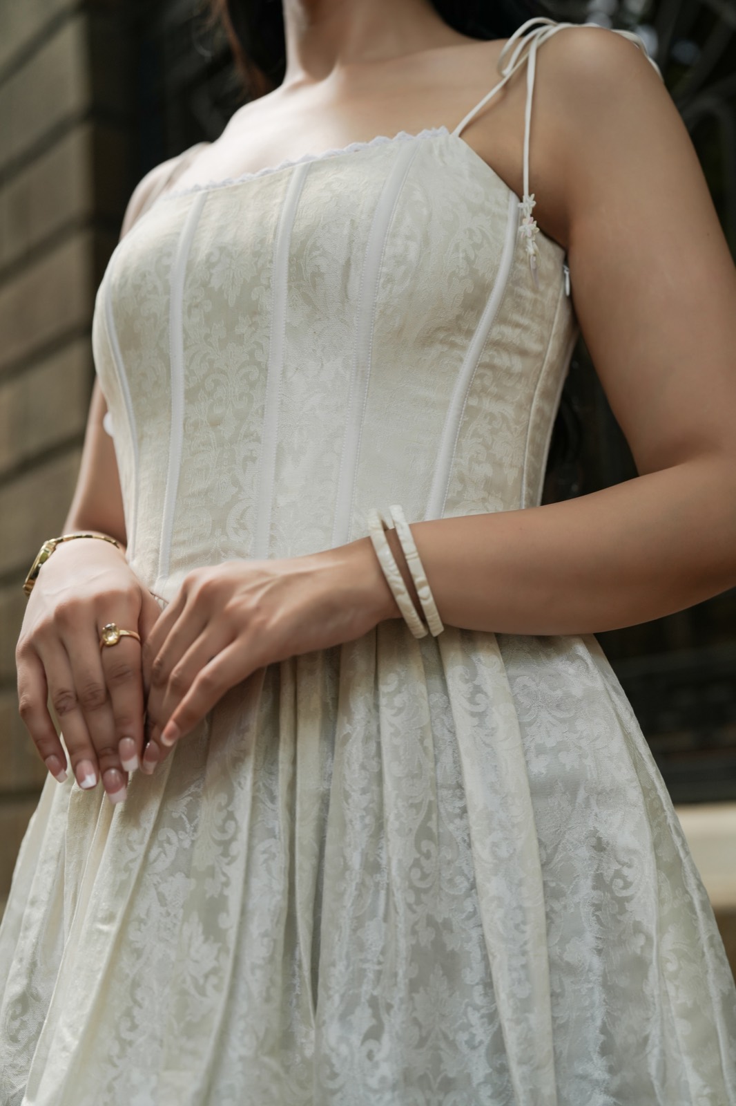 Sunset Brocade — the panelled bodice and the tie straps, each finished with a small tassel