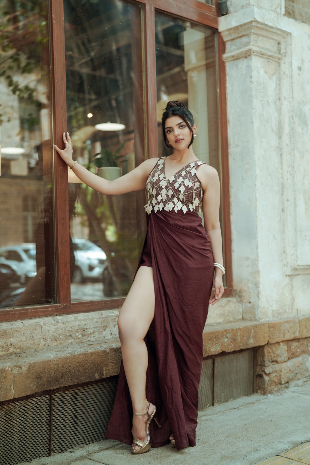 Ivory Drop — against a shopfront, the skirt open in a high slit at the side