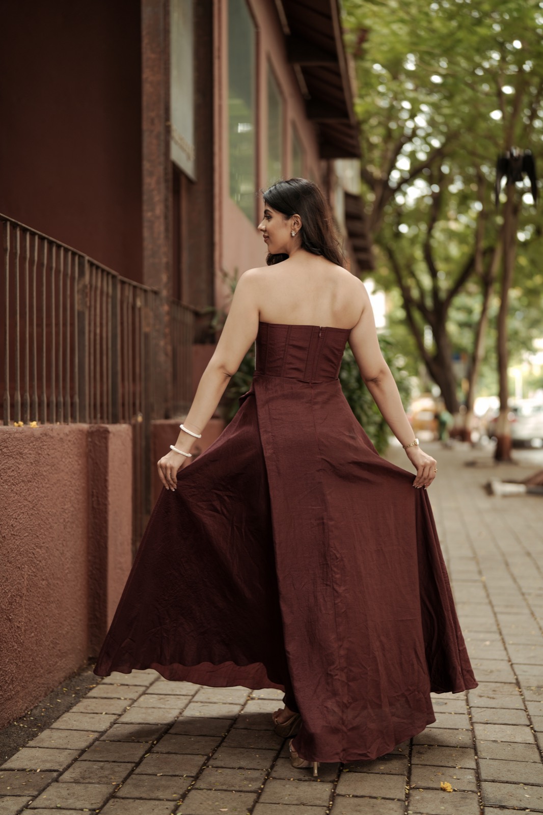 Pearl Syrup — seen from behind, the overlapped skirt falling open as she walks