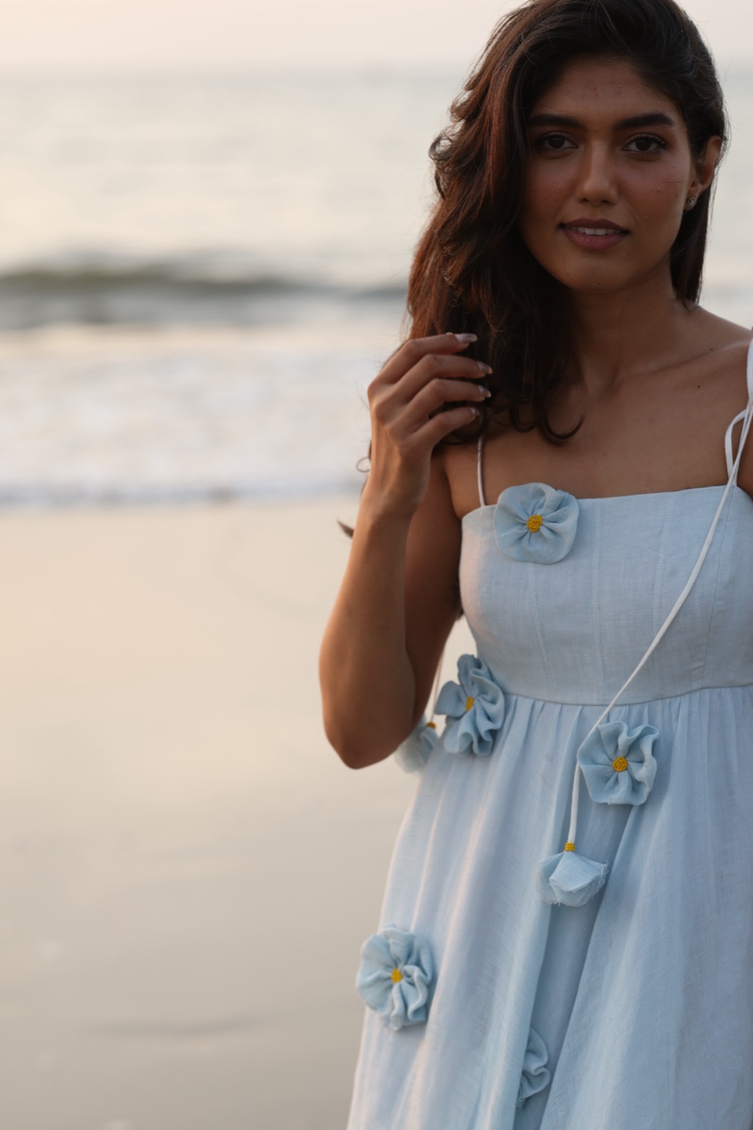 Powder Blue Bloom — close on the bodice and the hand-set blue flowers with yellow centres