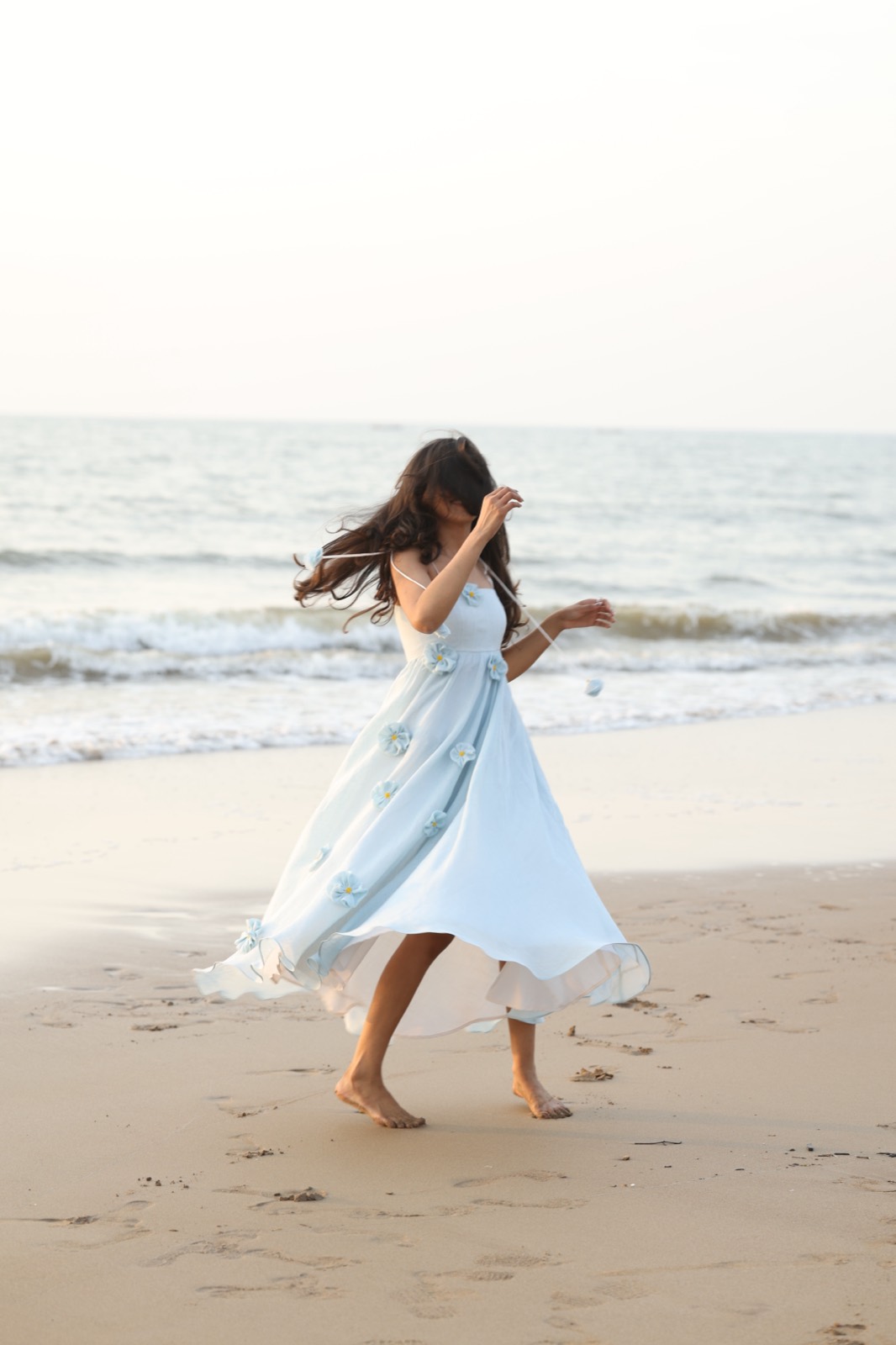 Powder Blue Bloom — the skirt caught mid-movement