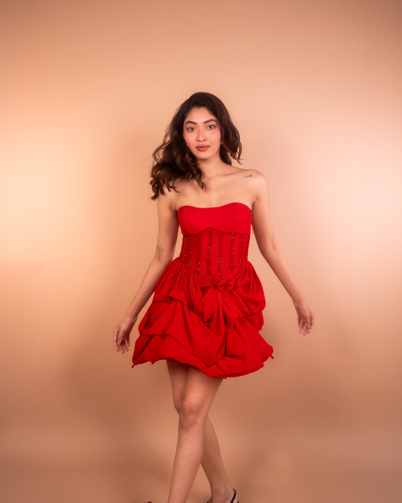 Ruby Bubble — strapless red bubble-hem mini, photographed against a tan studio backdrop