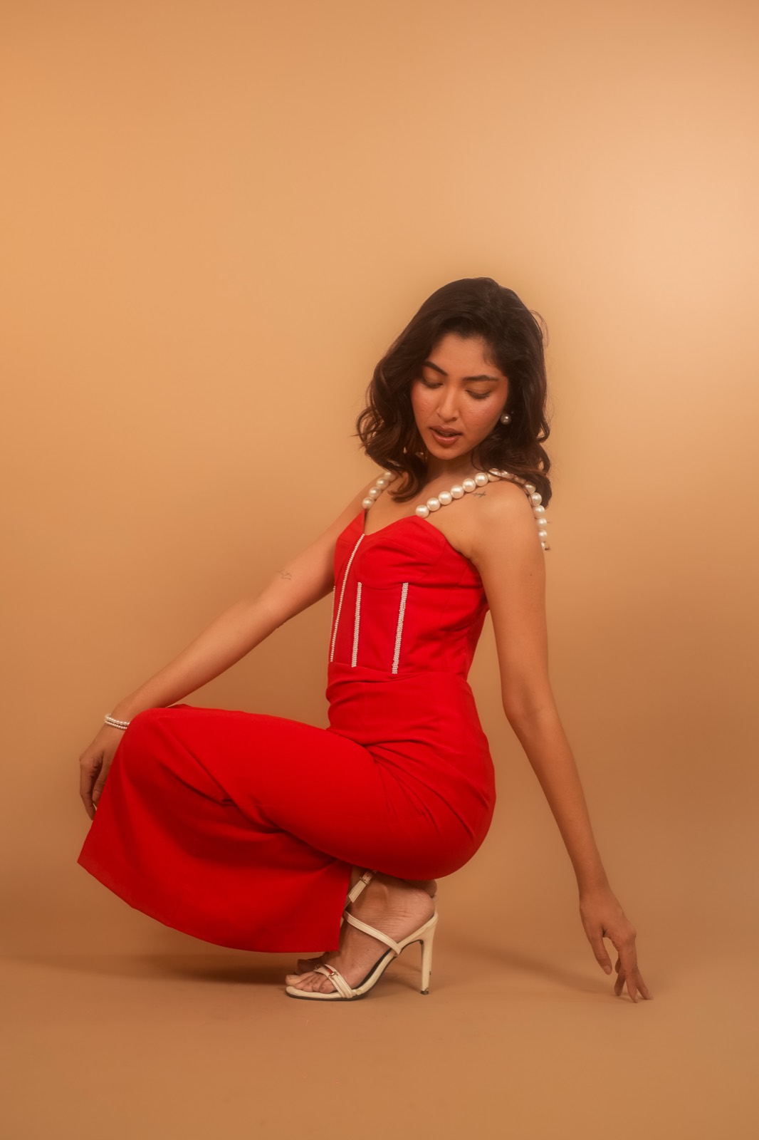 Scarlet — The skirt gathered, showing the weight of the cloth