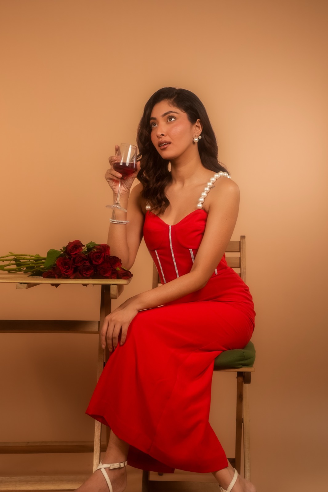 Scarlet — Seated at a table is the lady in red