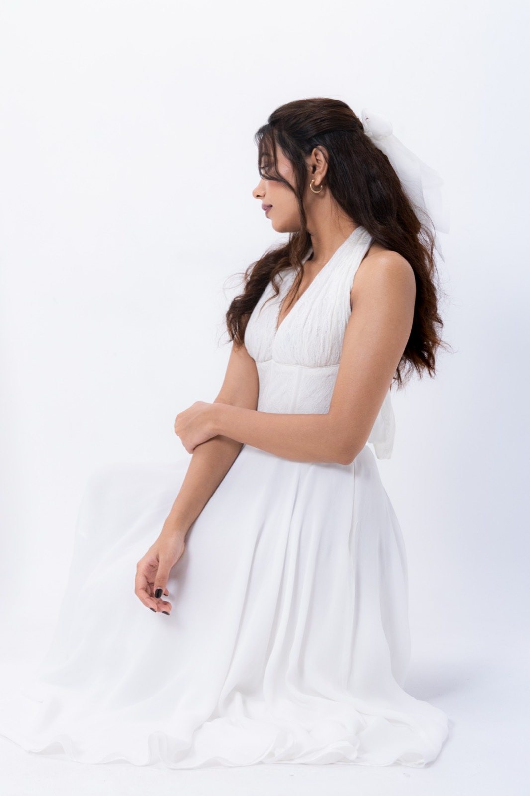 White Halter Midi — seated, the skirt spread across the floor