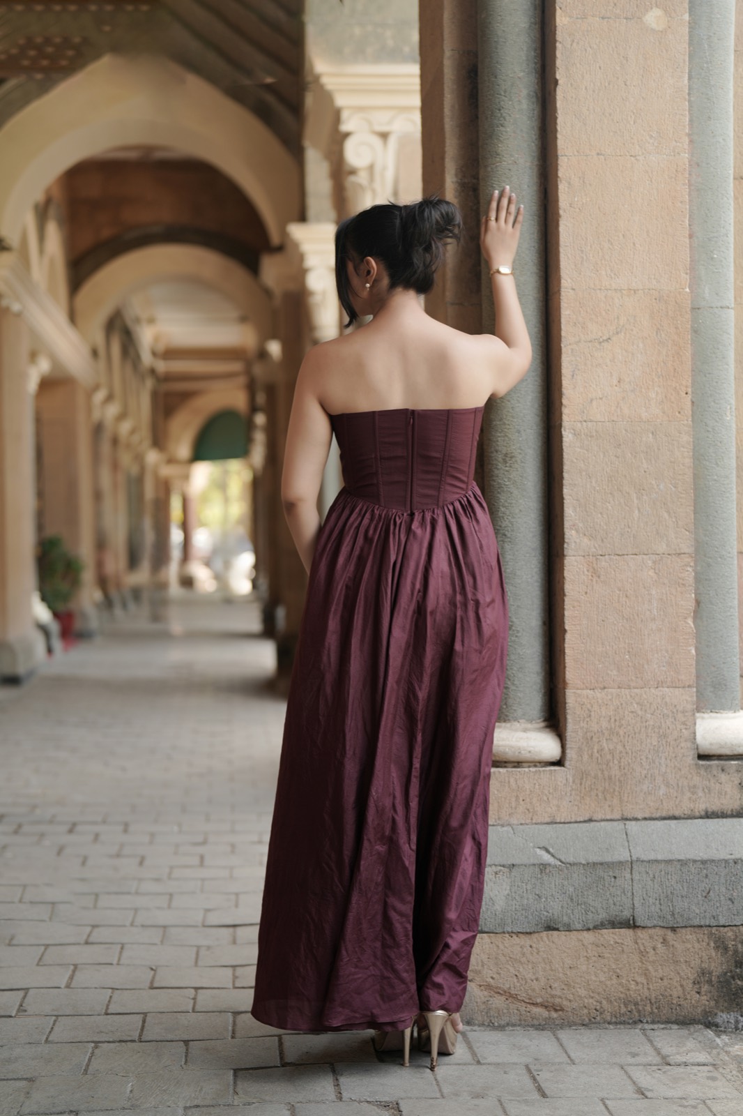 Pearl Galaxy — seen from behind, walking away down the arcade