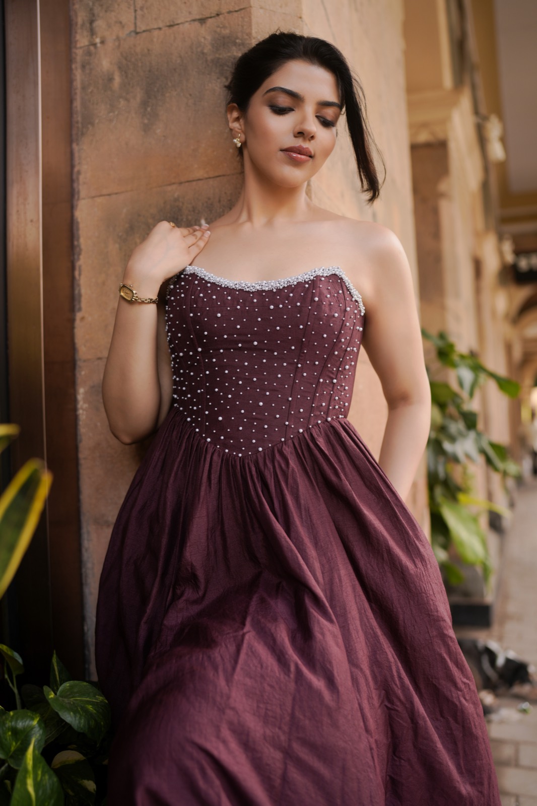 Pearl Galaxy — leaning against sandstone, the bodice in the light
