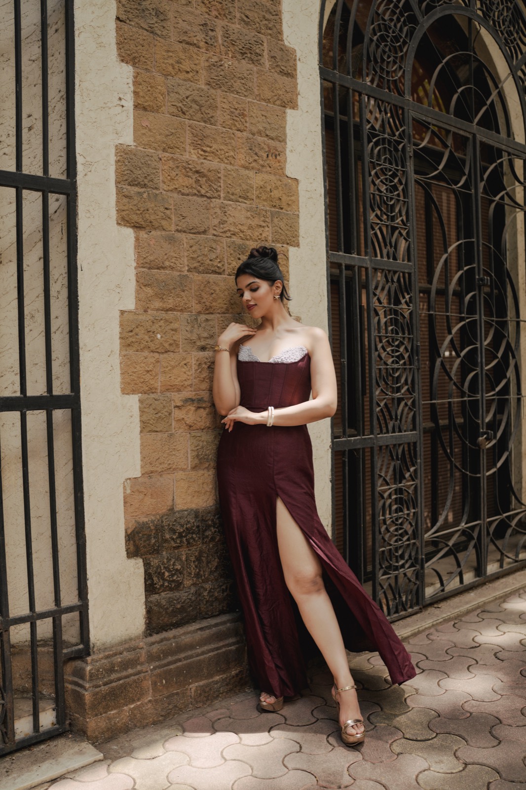 Claret Column — a wine column gown slit at the front, beside a wrought-iron gate